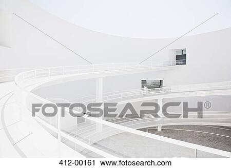 Curving elevated walkway in modern courtyard View Large Photo Image Stock Image - Curving elevated walkway in modern courtyard. Fotosearch