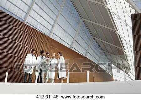 Doctors and businesswoman using digital tablet on modern balcony View Large Photo Image Stock Photo - Doctors and businesswoman using digital tablet on modern balcony. Fotosearch