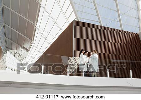 Stock Photo - Doctors talking on modern balcony. Fotosearch