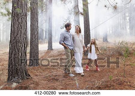 Happy family walking in woods View Large Photo Image Stock Image - Happy family walking in woods. Fotosearch