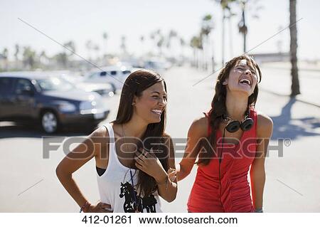 Laughing women walking outdoors View Large Photo Image Stock Image - Laughing women walking outdoors. Fotosearch