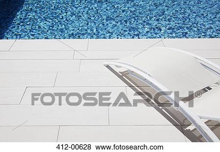 Lounge chair at poolside View Large Photo Image Stock Photo - Lounge chair at poolside. Fotosearch