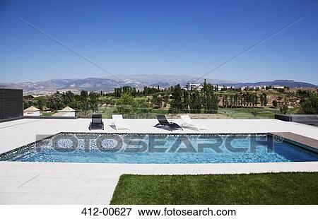 Lounge chairs and swimming pool View Large Photo Image Stock Photo - Lounge chairs and swimming pool. Fotosearch