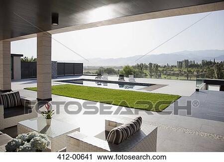 Luxury patio overlooking swimming pool and mountains View Large Photo Image Stock Image - Luxury patio overlooking swimming pool and mountains. Fotosearch