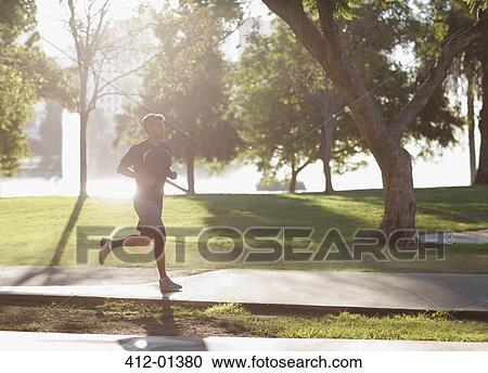 Man jogging in park View Large Photo Image Stock Image - Man jogging in park. Fotosearch