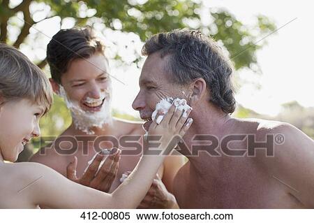 Stock Photography - Multi-generation men applying shaving cream to faces. Fotosearch