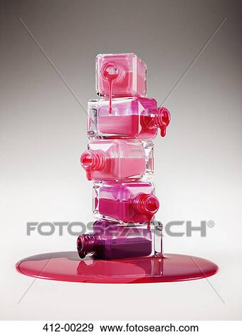 Multicolor fingernail polish dripping from stacked bottles View Large Photo Image Stock Photo - Multicolor fingernail polish dripping from stacked bottles. Fotosearch