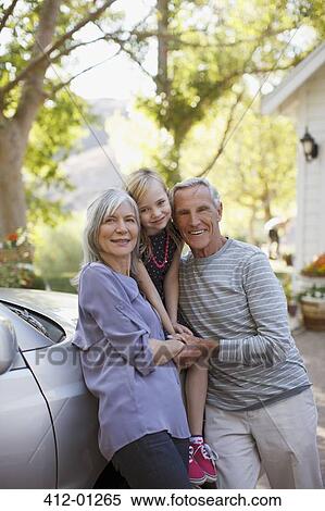 Older couple and granddaughter leaning on car View Large Photo Image Stock Photography - Older couple and granddaughter leaning on car. Fotosearch