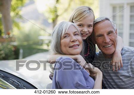 Older couple hugging granddaughter View Large Photo Image Stock Image - Older couple hugging granddaughter. Fotosearch