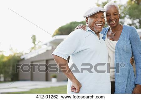 Older couple laughing together outdoors View Large Photo Image Stock Image - Older couple laughing together outdoors. Fotosearch
