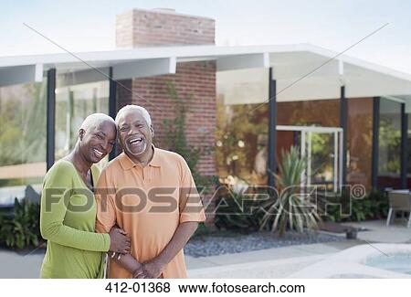 Stock Photo - Older couple smiling in backyard. Fotosearch