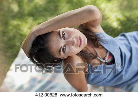 Overhead portrait of sexy woman sitting on blanket in grass View Large Photo Image Stock Photo - Overhead portrait of sexy woman sitting on blanket in grass. Fotosearch