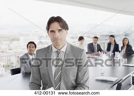 Portrait of confident business people in conference room View Large Photo Image Stock Image - Portrait of confident business people in conference room. Fotosearch