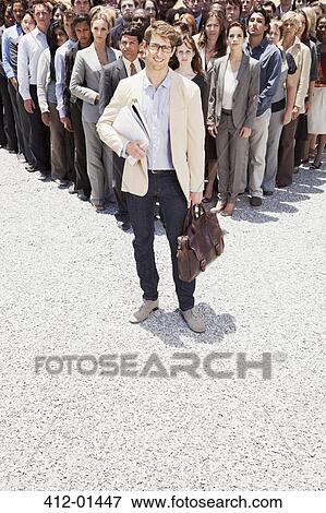 Portrait of confident businessman with business people in background View Large Photo Image Stock Photo - Portrait of confident businessman with business people in background. Fotosearch
