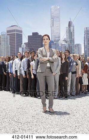 Portrait of confident businesswoman with business people in background View Large Photo Image Stock Image - Portrait of confident businesswoman with business people in background. Fotosearch
