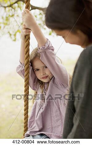 Portrait of girl on swing with mother View Large Photo Image Picture - Portrait of girl on swing with mother. Fotosearch