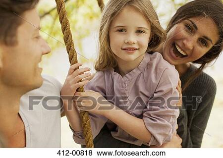 Portrait of happy family on swing View Large Photo Image Stock Photo - Portrait of happy family on swing. Fotosearch