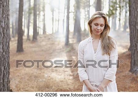 Portrait of serene woman in sunny woods View Large Photo Image Stock Photograph - Portrait of serene woman in sunny woods. Fotosearch
