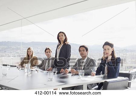 Portrait of serious business people at table in conference room View Large Photo Image Picture - Portrait of serious business people at table in conference room. Fotosearch