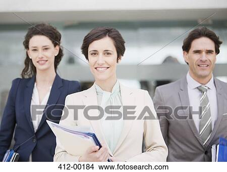 Portrait of smiling business people holding files View Large Photo Image Picture - Portrait of smiling business people holding files. Fotosearch