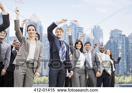 Stock Photography - Portrait of smiling business people waving American flags. Fotosearch