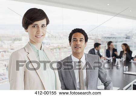 Portrait of smiling businessman and businesswoman in conference room View Large Photo Image Stock Photography - Portrait of smiling businessman and businesswoman in conference room. Fotosearch