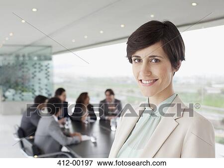 Stock Photo - Portrait of smiling businesswoman in conference room. Fotosearch