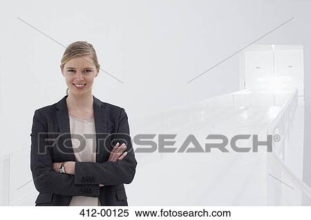 Portrait of smiling businesswoman with arms crossed View Large Photo Image Stock Photography - Portrait of smiling businesswoman with arms crossed. Fotosearch