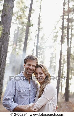 Picture - Portrait of smiling couple in woods. Fotosearch