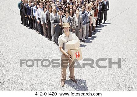 Portrait of smiling delivery woman with business people in background View Large Photo Image Stock Image - Portrait of smiling delivery woman with business people in background. Fotosearch