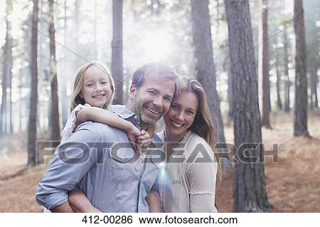 Portrait of smiling family in sunny woods View Large Photo Image Stock Photograph - Portrait of smiling family in sunny woods. Fotosearch