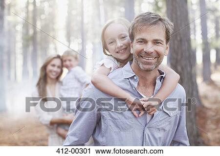 Portrait of smiling family in woods View Large Photo Image Stock Image - Portrait of smiling family in woods. Fotosearch