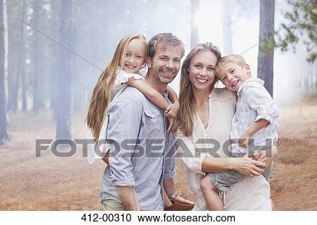 Portrait of smiling family in woods View Large Photo Image Stock Image - Portrait of smiling family in woods. Fotosearch