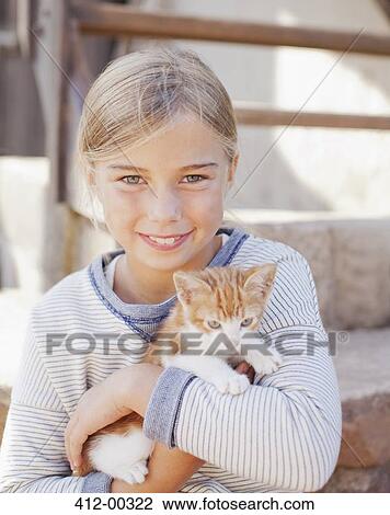 Portrait of smiling girl holding kitten View Large Photo Image Stock Image - Portrait of smiling girl holding kitten. Fotosearch