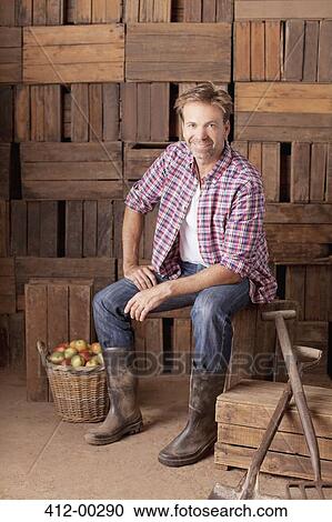 Portrait of smiling man sitting next to bushel of apples View Large Photo Image Stock Image - Portrait of smiling man sitting next to bushel of apples. Fotosearch