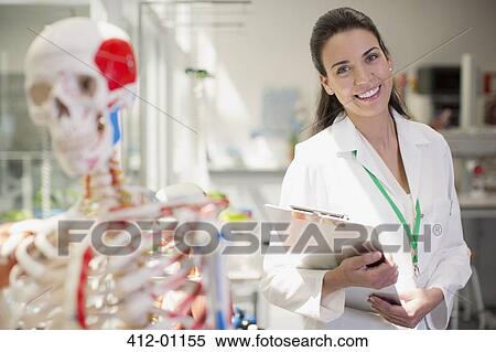 Portrait of smiling scientist with anatomical model and clipboard in laboratory View Large Photo Image Stock Photography - Portrait of smiling scientist with anatomical model and clipboard in laboratory. Fotosearch