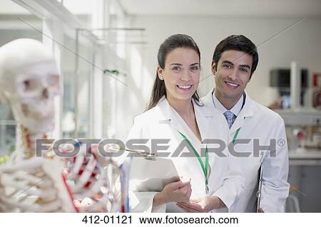 Stock Image - Portrait of smiling scientists in laboratory. Fotosearch