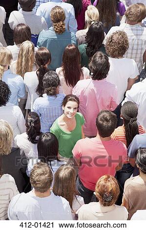 Portrait of smiling woman among crowd View Large Photo Image Stock Image - Portrait of smiling woman among crowd. Fotosearch