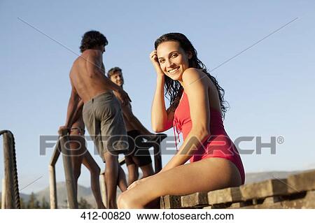 Portrait of smiling woman in bathing suit on dock View Large Photo Image Stock Image - Portrait of smiling woman in bathing suit on dock. Fotosearch
