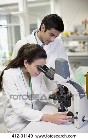 Scientists using microscope in laboratory View Large Photo Image Stock Photo - Scientists using microscope in laboratory. Fotosearch