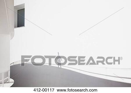 Shadow of businessman leaning on railing View Large Photo Image Stock Photo - Shadow of businessman leaning on railing. Fotosearch