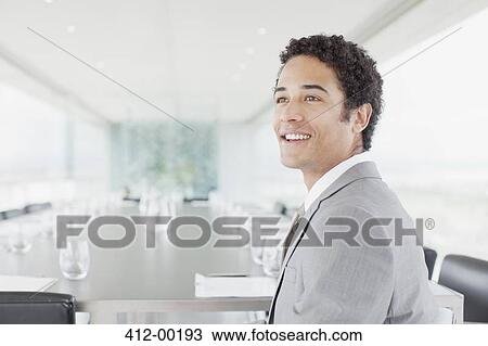 Smiling businessman in conference room View Large Photo Image Stock Image - Smiling businessman in conference room. Fotosearch