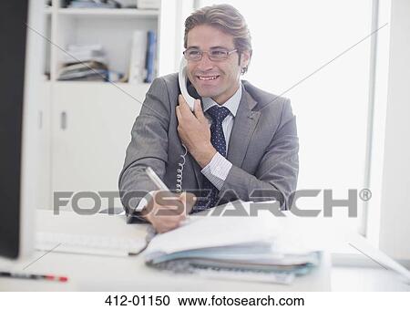 Smiling businessman talking on telephone and writing View Large Photo Image Stock Image - Smiling businessman talking on telephone and writing. Fotosearch