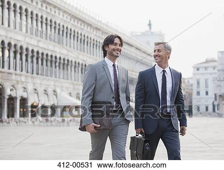 Smiling businessmen walking across St. Mark's Square in Venice View Large Photo Image Stock Image - Smiling businessmen walking across St. Mark's Square in Venice. Fotosearch