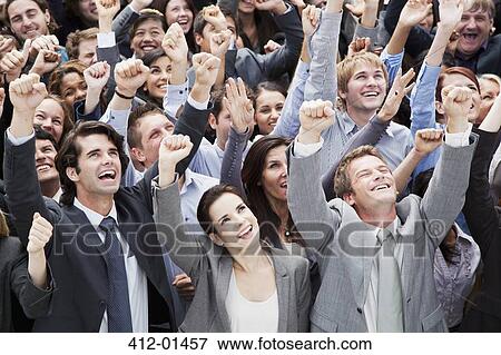 Smiling crowd of business people cheering with arms raised View Large Photo Image Stock Photo - Smiling crowd of business people cheering with arms raised. Fotosearch