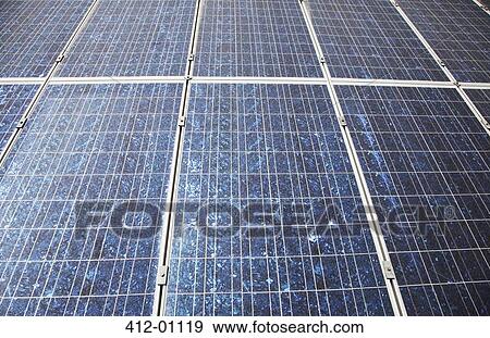 Stock Photo - Sun shining on solar panels. Fotosearch