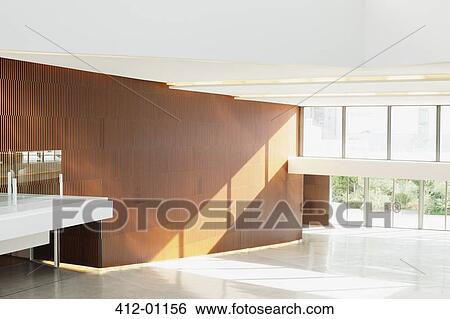 Sun shining through windows in empty modern lobby View Large Photo Image Stock Photograph - Sun shining through windows in empty modern lobby. Fotosearch