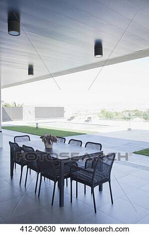 Table and chairs on patio View Large Photo Image Stock Image - Table and chairs on patio. Fotosearch