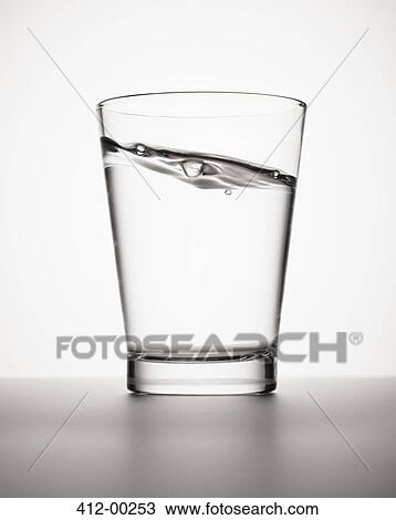 Water sloshing in glass View Large Photo Image Stock Image - Water sloshing in glass. Fotosearch
