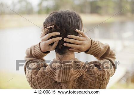 Woman with hair in hands at lakeside View Large Photo Image Stock Photography - Woman with hair in hands at lakeside. Fotosearch